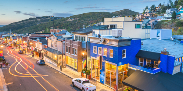 Snow-covered Main Street in Park City, Utah, during winter, featuring historic buildings and mountain views, symbolizing the local real estate market and lifestyle.